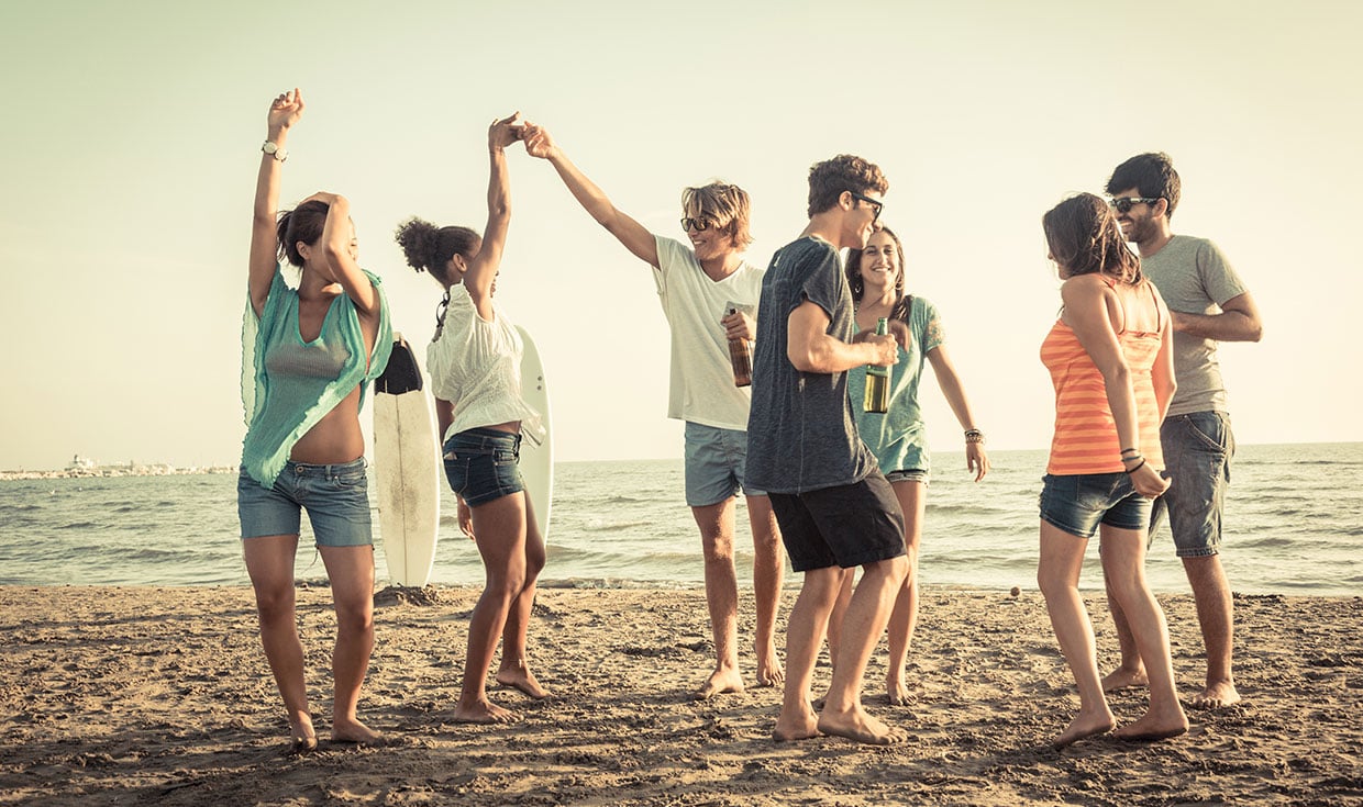 Group of people on the beach dancing