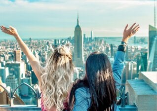 Two young women looking out over the Empire State Building