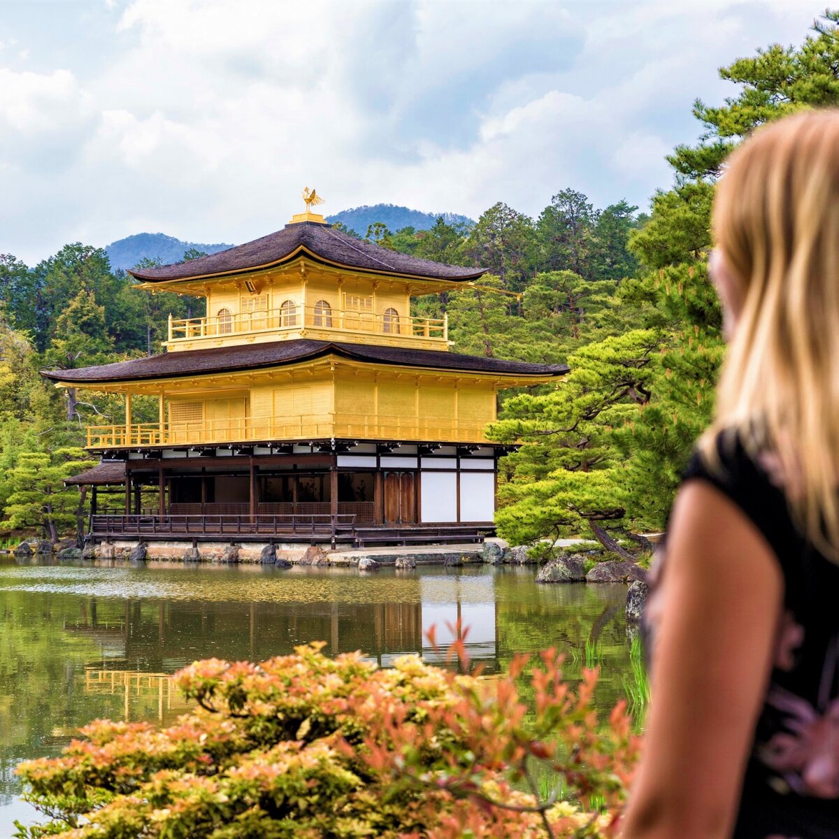 Traveller looking at golden pavillion in Japan